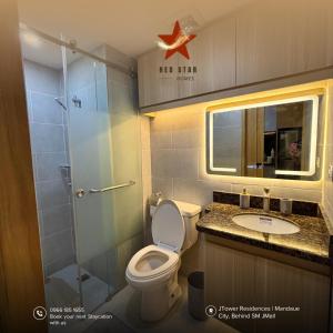 a bathroom with a toilet and a shower and a sink at JTower Residences Mandaue in Mandaue City