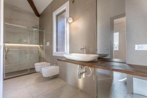 a bathroom with a sink and a toilet at Suite Home Ferrara in Ferrara +74 photos