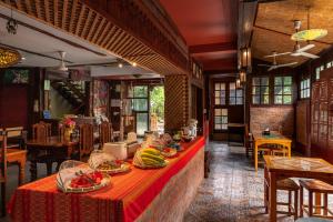 a restaurant with a table with plates of food on it at Boutique House Nipha in Chiang Mai
