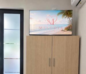 a flat screen tv on top of a dresser at Melody's Room in Borsh