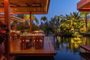 a restaurant with tables and chairs on a wooden deck at Four Seasons Hotel in Limassol