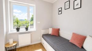a room with a couch and a window at Serce Kotliny Kłodzkiej - Apartament 54m2 - 3 pokoje, balkon, ogródek in Kłodzko