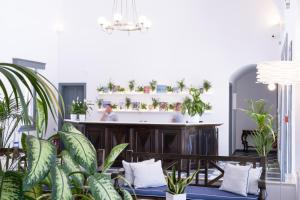 a bathroom with a bath tub with plants at Rose Bay Hotel in Kamari