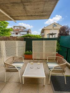 a patio with two chairs and a table with drinks on it at Hotel Parigi 2 & Spa in Dalmine