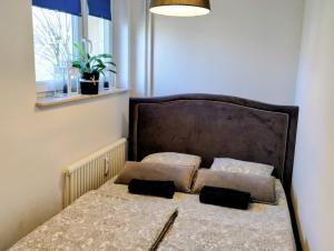 a bed with two pillows on it in a room at Studio Park Śląski m.10 Katowice/Chorzów in Chorzów