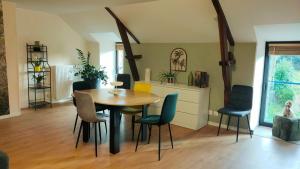 a dining room with a table and chairs at Gîte L'Orée des Bois in Paimpont