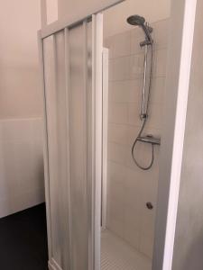 a shower with a glass door in a bathroom at Casa Mate in Bra