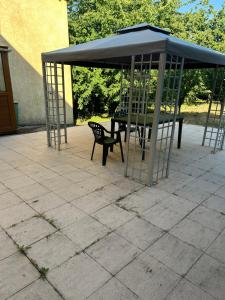 a gazebo with a table and a chair under it at LEMAFIOlY in Cemboing
