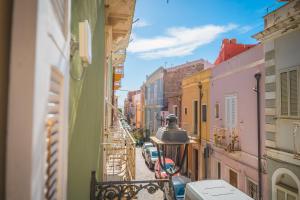 a view from a balcony of a street with buildings at Inderooms Carloforte in Carloforte