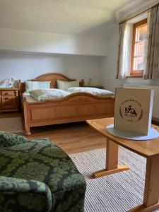 a room with two beds and a laptop on a table at Guggenbergerhof in Maria Luggau
