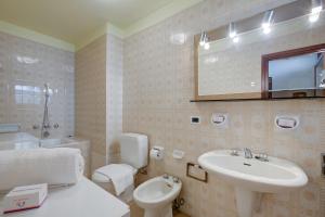 a bathroom with a sink and a toilet and a mirror at Lo Stambecco - Duplex for 8 people - Happy Rentals in Bardonecchia