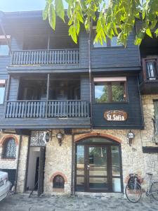 a building with a sign that reads x suite at Saint Sofia Guest House Къща за Гости in Nesebar
