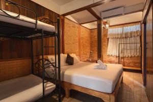a bedroom with two bunk beds and a window at Boutique House Nipha in Chiang Mai +192 photos