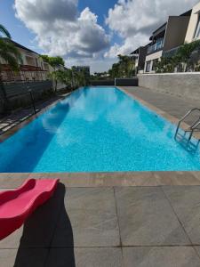 a large swimming pool with blue water in a building at Prosperity House Southlinks in Bagam