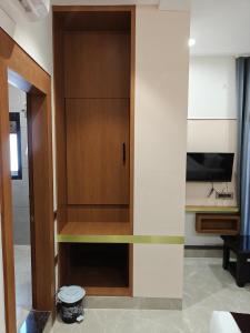 a room with a cabinet with a tv in it at Hotel ROYAL DC in Alīgarh