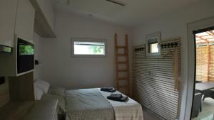 a small bedroom with a bed and a window at Tiny House Krumlov, Terrace, Parking in Český Krumlov