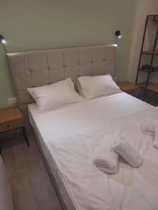 a large white bed with two white socks on it at Resort Finikas in Alexandroupoli +76 photos