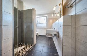 a bathroom with a shower and a sink at Haus Schildt, FeWo 8 in Duhnen