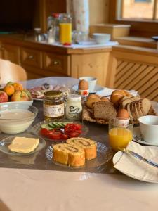 a table with bread and other food on it at Guggenbergerhof in Maria Luggau +29 photos