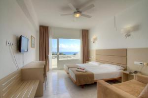 a hotel room with two beds and a balcony at Lago Playa in Es Pujols +66 photos