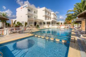 a swimming pool in front of a hotel at Lago Playa in Es Pujols