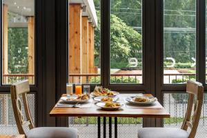 a table with plates of food on top of it at Flora Creek Chiang Mai in Hang Dong