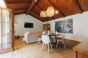 a dining room with a table and chairs and a couch at City Bungalow in Schladming