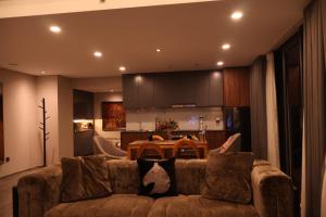 a living room with a couch and a table at Casahindout in Hanoi