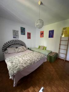 a bedroom with a bed and a chair in it at Notre campagne provençale in Avignon +17 photos