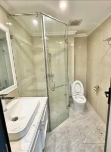a bathroom with a shower and a toilet and a sink at Buthaina Royal Resort in Bidbid