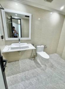 a bathroom with a toilet and a sink and a mirror at Buthaina Royal Resort in Bidbid