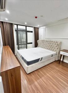 a bedroom with a large bed with a large window at Buthaina Royal Resort in Bidbid