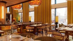 a restaurant with tables and chairs and windows at Petra Hotel Belgrade in Belgrade +20 photos