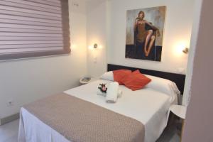 a bedroom with a bed with flowers on it at RNET - IR29218 Studios Roses Costa Brava in Roses +20 photos