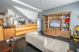 a living room with a couch and a tv at Hotel Rubicone in Savignano sul Rubicone