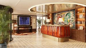 a hotel lobby with a bar and a television at Petra Hotel Belgrade in Belgrade