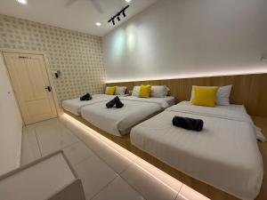 two beds in a hotel room with lights on them at Seri Botani Private Pool Villa 5BR in Ipoh +45 photos