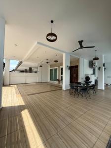 an empty living room with a table and chairs at Seri Botani Private Pool Villa 5BR in Ipoh