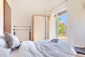 a bedroom with a bed and a large window at Villa Lara 1 in Ližnjan
