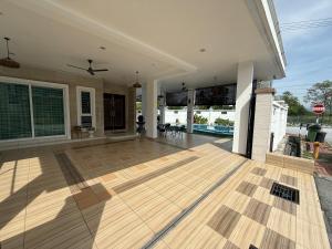 a large living room with a wooden floor at Seri Botani Private Pool Villa 5BR in Ipoh