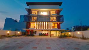 a large building with a balcony in the evening at Bliss Giriya By Bergamont in Tiruvannāmalai