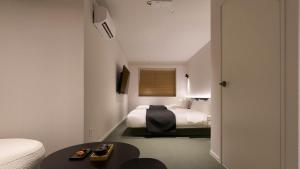 a hotel room with two beds and a table at Anook Hotel Ulsan Mugeo in Ulsan