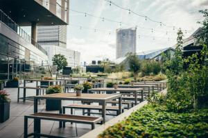 a row of tables and benches on a patio at Radisson Blu Hotel, Bonn in Bonn