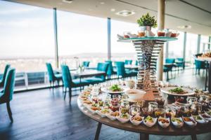 a table filled with appetizers and plates of food at Radisson Blu Hotel, Bonn in Bonn