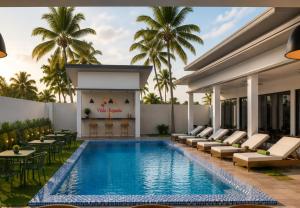 a pool at the resort with lounge chairs and a fireplace at Villa España in San Narciso