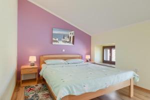a bedroom with a bed and a purple wall at Apartments Horizon in Pazin +63 photos