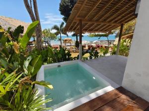 a hot tub on the patio of a resort at Nomad Beach House, Koh Lanta in Ko Lanta