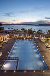 a large swimming pool with a view of the ocean at The Komana Dardanelles in Hamidiye