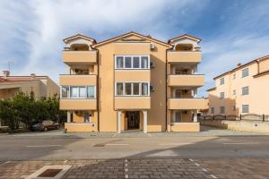 a large apartment building in a parking lot at Apartment Vallera in Medulin