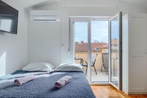 a bedroom with a bed with two towels on it at Apartment Vallera in Medulin